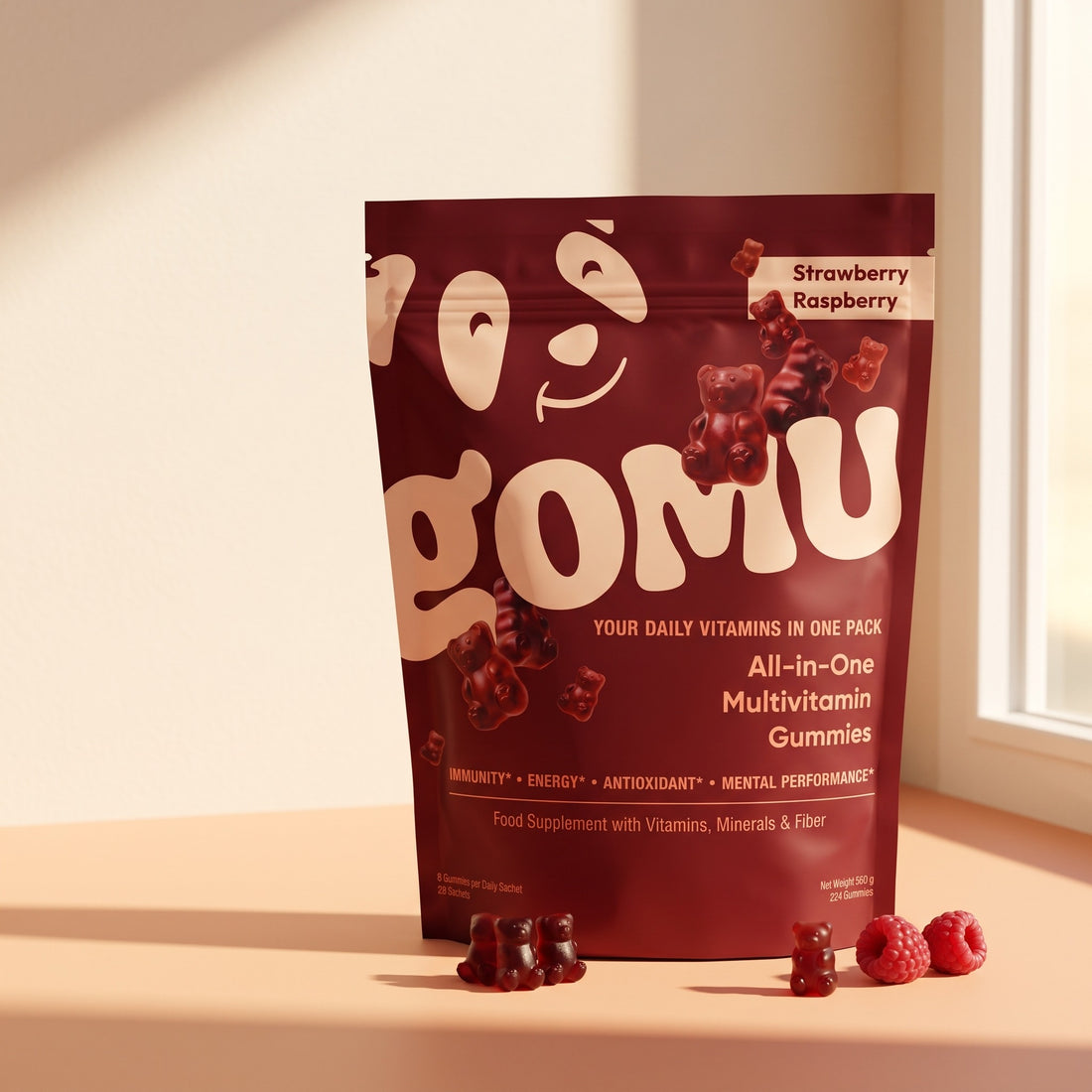 GOMU multivitamin gummies burgundy pouch in warm sunlight with gummy bears and raspberries