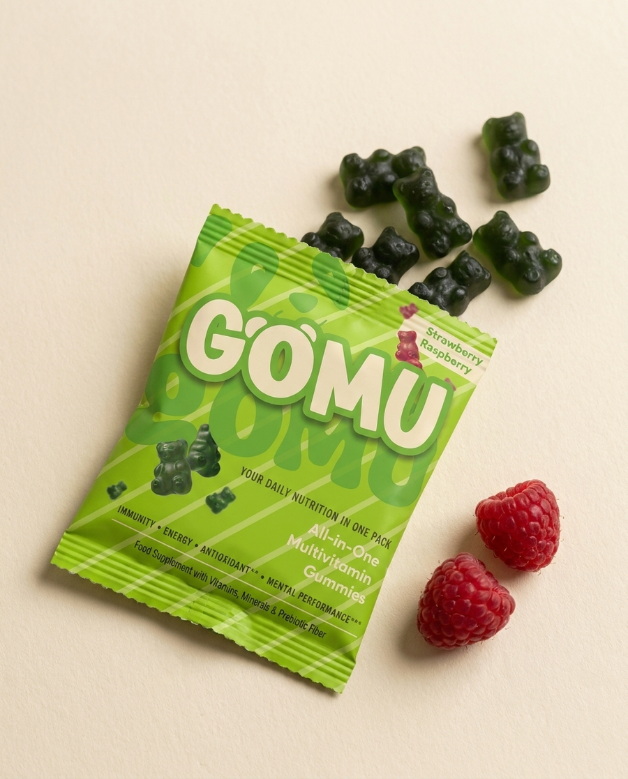 GOMU sachet torn open with dark green gummy bears