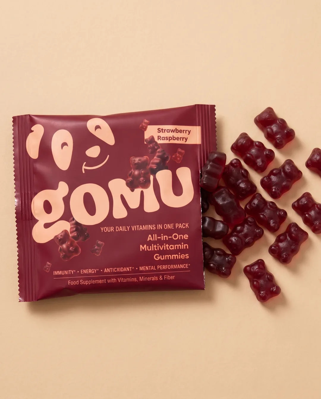 A GOMU daily sachet with gummies scattered beside it