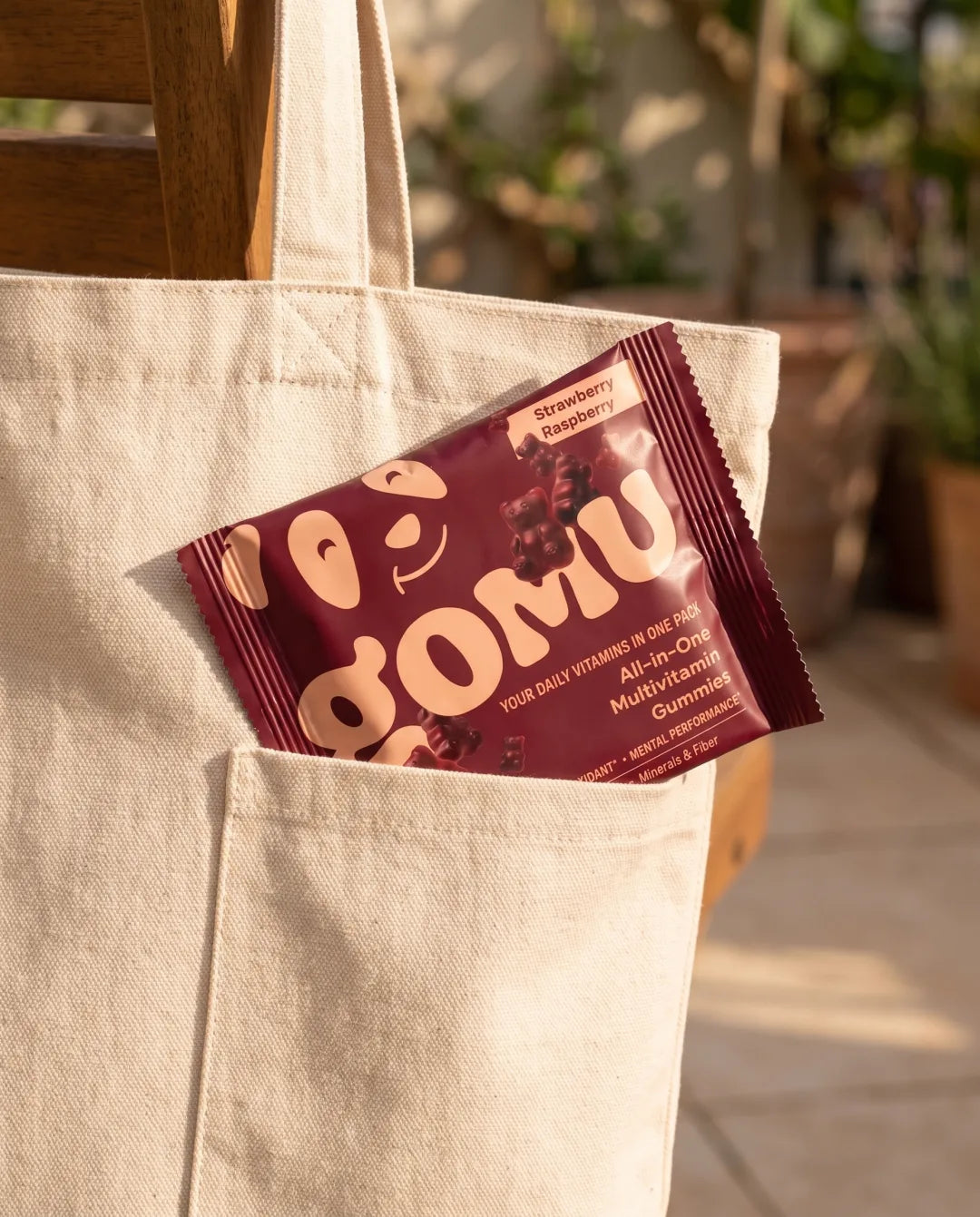 A GOMU daily sachet in the pocket of a tote bag